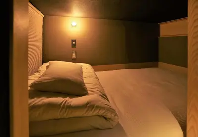 a bedroom with a large white bed in a room at AET & o3 HOTEL in Tokyo