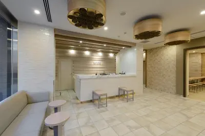 a lobby of a hotel with tables and stools at Hotel Il Fiore Kasai in Tokyo