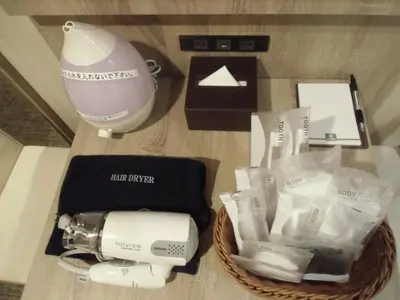 a table with a hair dryer a blender and a box at Hotel Il Fiore Kasai in Tokyo