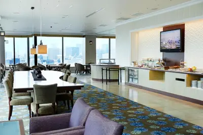 a restaurant with a table and chairs and a kitchen at Royal Park Hotel in Tokyo