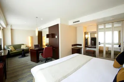 a hotel room with a bed and a desk at Royal Park Hotel in Tokyo