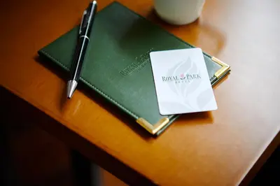 a notebook on a table with a pen and a book at Royal Park Hotel in Tokyo