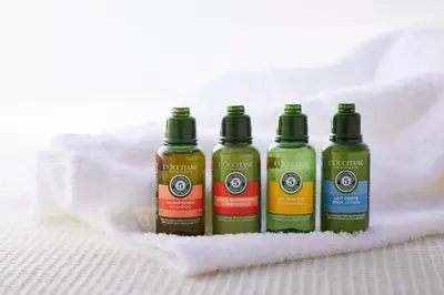 a group of three bottles of liquid sitting on a towel at Royal Park Hotel in Tokyo