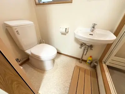 a bathroom with a toilet and a sink at House Ikebukuro in Tokyo
