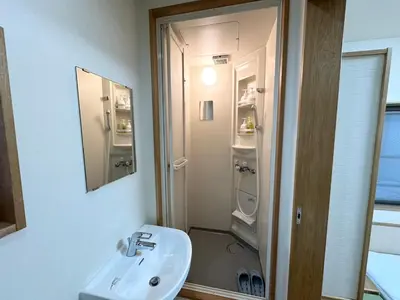 a bathroom with a sink and a shower at House Ikebukuro in Tokyo