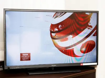 a flat screen tv sitting on a wooden stand at APA Hotel TKP Tokyo Nishi-Kasai in Tokyo