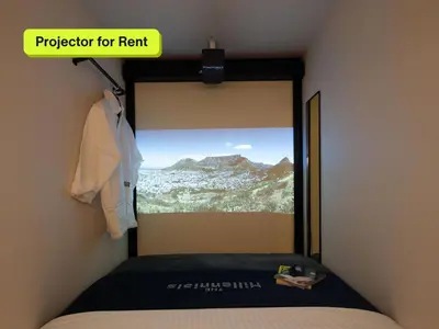 a bedroom with a window with a mountain view at The Millennials Shibuya in Tokyo