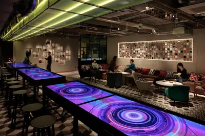 a bar with blue and purple lights on the counter at The Millennials Shibuya in Tokyo