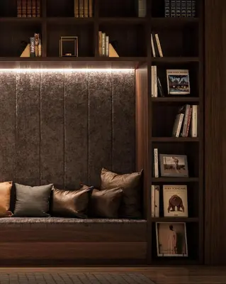 a living room with a couch in a book shelf at Nest Hotel Tokyo Hanzomon in Tokyo