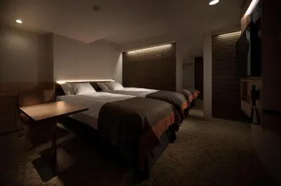 a hotel room with four beds and a window at Nest Hotel Tokyo Hanzomon in Tokyo
