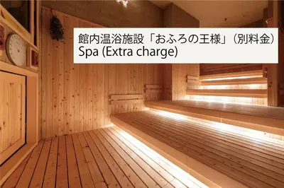 an empty wooden sauna with a clock on top at Ours Inn Hankyu in Tokyo