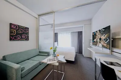 a hotel room with a couch and a bed at Citadines Shinjuku Tokyo in Tokyo