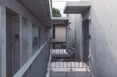 an empty hallway with stairs in a building at bmj Shinjuku Okubo in Tokyo