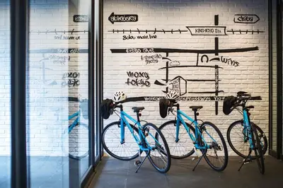 two bikes parked in front of a wall with graffiti at MOXY Tokyo Kinshicho in Tokyo