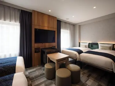 a hotel room with two beds and a flat screen tv at THE KNOT TOKYO Shinjuku in Tokyo