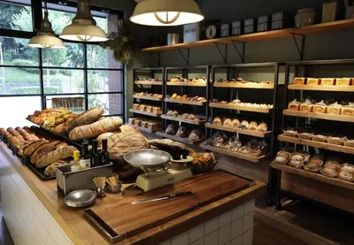 a bakery with lots of bread and pastries on display at THE KNOT TOKYO Shinjuku in Tokyo