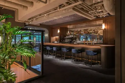 a bar in a restaurant with stools at THE KNOT TOKYO Shinjuku in Tokyo