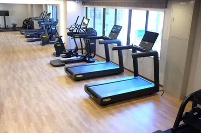 a row of exercise machines in a gym at THE KNOT TOKYO Shinjuku in Tokyo