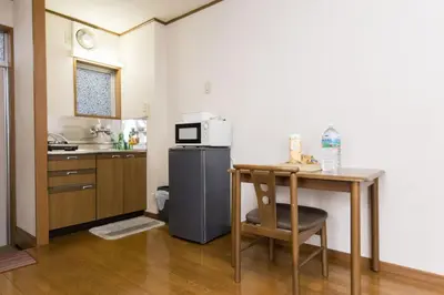 a small kitchen with a table and a microwave at Shinjuku Apartments 101 in Tokyo