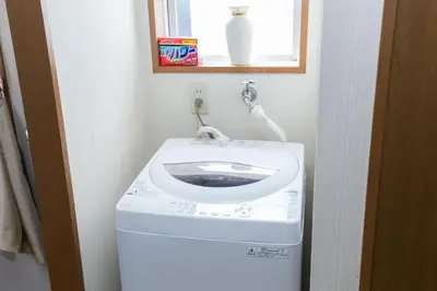 a washing machine with a sink on top of it at Shinjuku Apartments 101 in Tokyo