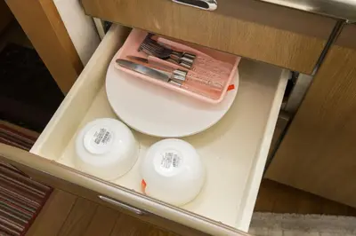 a drawer with three knives and a plate in it at Shinjuku Apartments 101 in Tokyo