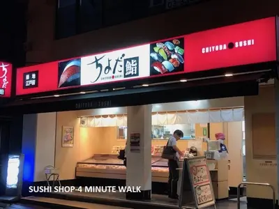 a man standing at the counter of a restaurant at Shinjuku Apartment 103 in Tokyo