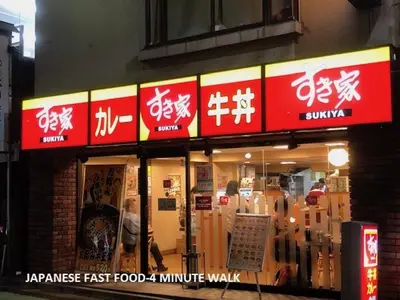 a fast food restaurant with asian signs on the front of it at Shinjuku Apartment 102 in Tokyo