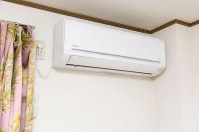 a wall mounted air conditioner in a room at Shinjuku Apartment 102 in Tokyo