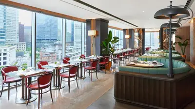 a restaurant with tables and chairs and windows at Four Seasons Hotel Tokyo at Marunouchi in Tokyo