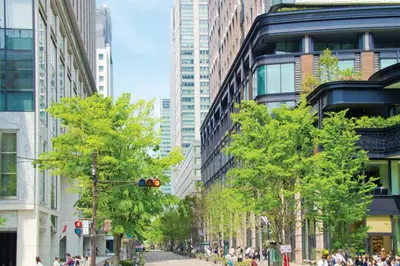 a street in a city with tall buildings at Four Seasons Hotel Tokyo at Marunouchi in Tokyo