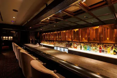 a bar with a bunch of bottles of alcohol at Hotel Metropolitan Edmont Tokyo in Tokyo