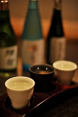 a tray with three bowls and bottles of wine at Hotel Metropolitan Edmont Tokyo in Tokyo