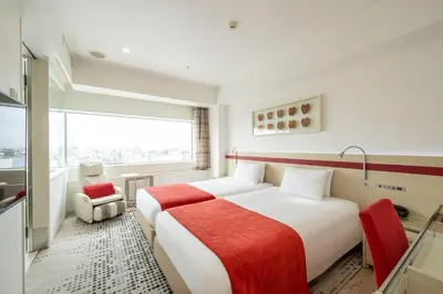 a hotel room with a large bed and a window at remm Akihabara in Tokyo
