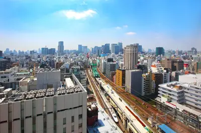a view of a city with train tracks and buildings at remm Akihabara in Tokyo