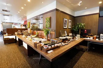 a buffet line with food on a long table at Hotel Sardonyx Tokyo in Tokyo