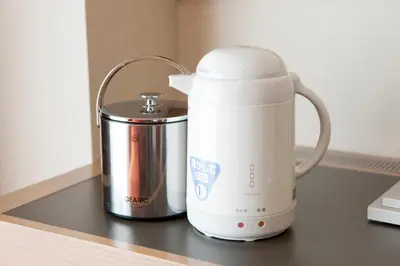 a white appliance sitting on a counter next to a tin at Hotel Sardonyx Tokyo in Tokyo