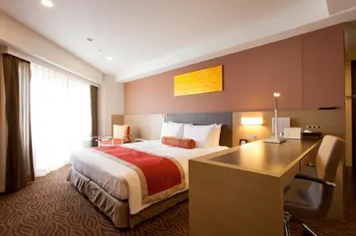 a hotel room with a bed and a desk at Hotel Sardonyx Tokyo in Tokyo