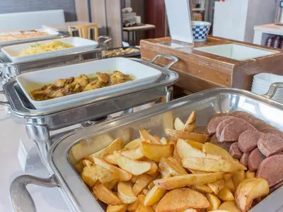 a buffet with several trays of food and french fries at Hearton Hotel Higashi-Shinagawa in Tokyo