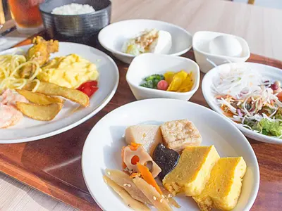 a table with plates of food and bowls of food at Hearton Hotel Higashi-Shinagawa in Tokyo
