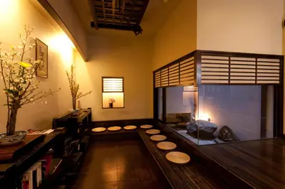 a living room with a fish tank in the middle at Kimi Ryokan in Tokyo