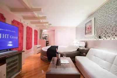 a living room with a couch and a tv at HOTEL PERRIER (Adult Only) in Tokyo
