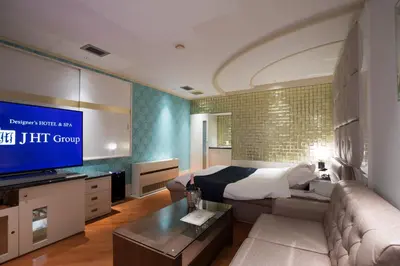 a living room with a couch and a tv at HOTEL PERRIER (Adult Only) in Tokyo