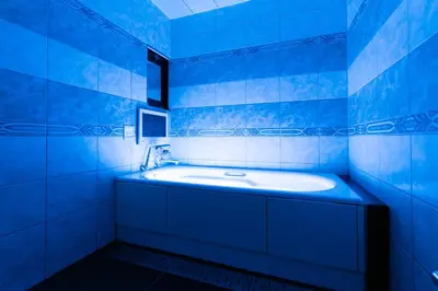 a blue tiled bathroom with a tub in it at HOTEL PERRIER (Adult Only) in Tokyo