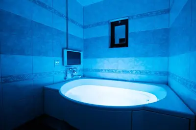 a blue bathroom with a tub and a mirror at HOTEL PERRIER (Adult Only) in Tokyo