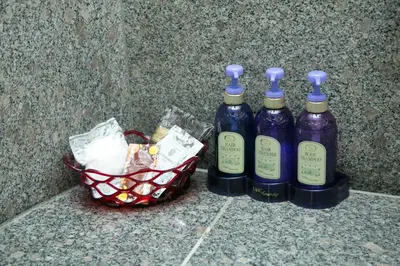 three bottles of wine sitting next to a basket at HOTEL PERRIER (Adult Only) in Tokyo