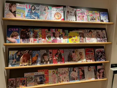 a book shelf filled with magazines and books at Glansit Akihabara in Tokyo