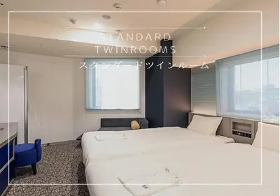 a bedroom with a large white bed and a window at Henn na Hotel Tokyo Hamamatsucho in Tokyo
