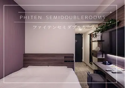 a bedroom with a large bed and a mirror at Henn na Hotel Tokyo Hamamatsucho in Tokyo