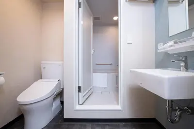 a bathroom with a toilet and a sink at Henn na Hotel Tokyo Asakusabashi in Tokyo