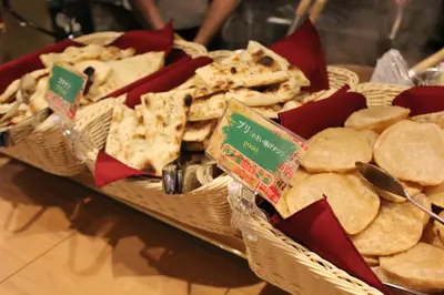a table with two baskets of bread and crackers at Henn na Hotel Tokyo Asakusabashi in Tokyo